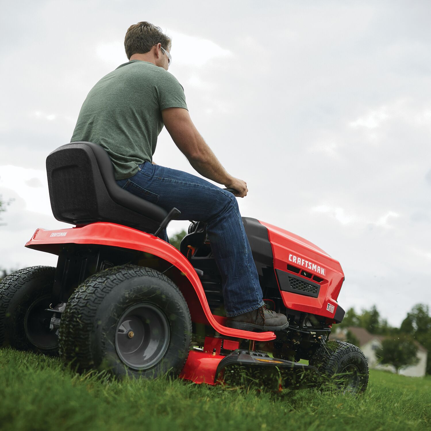 Homeowner mowing a large lawn with the CRAFTSMAN T110
